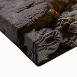 Close-up of a stretched canvas artwork depicting a serene landscape with caves, showcasing intricate details and vibrant colors, perfect for home decor.