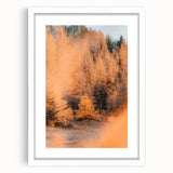 Abstract art print featuring warm fall colors in a white frame, ideal for dining room or bedroom decor.
