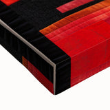 Close-up of abstract wall art on stretched canvas, featuring vibrant strokes in shades of blue, orange, and yellow, perfect for modern home decor.