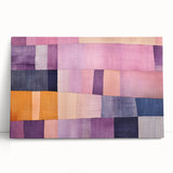 Abstract wall art featuring vibrant strokes in blue, orange, and yellow on a stretched canvas, leaning against a neutral wall, adding a modern touch to decor. Perfect for contemporary interiors.