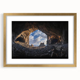 Framed landscape artwork depicting a cave scene with a gold mat and elegant frame, showcasing intricate details and rich colors, ideal for home decor.