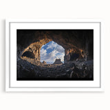 Framed landscape artwork depicting a serene cave view, featuring a white mat and sleek black frame, perfect for enhancing home decor and adding a natural touch.