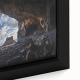 Close-up of a framed canvas artwork depicting a vibrant landscape with caves, showcasing intricate details and rich colors, perfect for home decor.