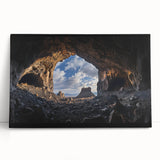 Stretched canvas artwork depicting a serene landscape with caves and lush greenery, elegantly leaning against a wall, perfect for home decor and interior design.