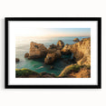 Black-framed landscape artwork showcasing dramatic cliffs and serene nature, highlighted by a white mat, perfect for modern home decor and interior design.