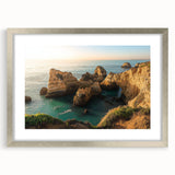 Framed landscape artwork depicting cliffs in a silver mat, showcasing natural scenery with vibrant colors, ideal for home or office decor.