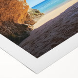 Rolled canvas showcasing a serene beach landscape with vibrant colors and soft waves, elegantly packaged in a protective cardboard tube for safe shipping.