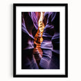 Framed landscape art print showcasing vibrant canyons in rich earth tones, set in a sleek black frame with a white mat, ideal for modern home decor.