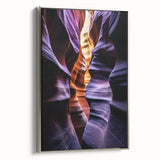 Framed canvas artwork depicting a stunning landscape of canyons, featuring vibrant colors and intricate details, showcased from a side view with a sleek silver frame.