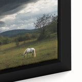 Close-up of a framed canvas showcasing a serene countryside landscape, highlighting lush green fields and soft blue skies, perfect for home decor and nature lovers.