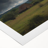Rolled canvas showcasing a serene countryside landscape with vibrant green fields and a clear blue sky, packaged securely in a protective cardboard tube. Ideal for home decor.