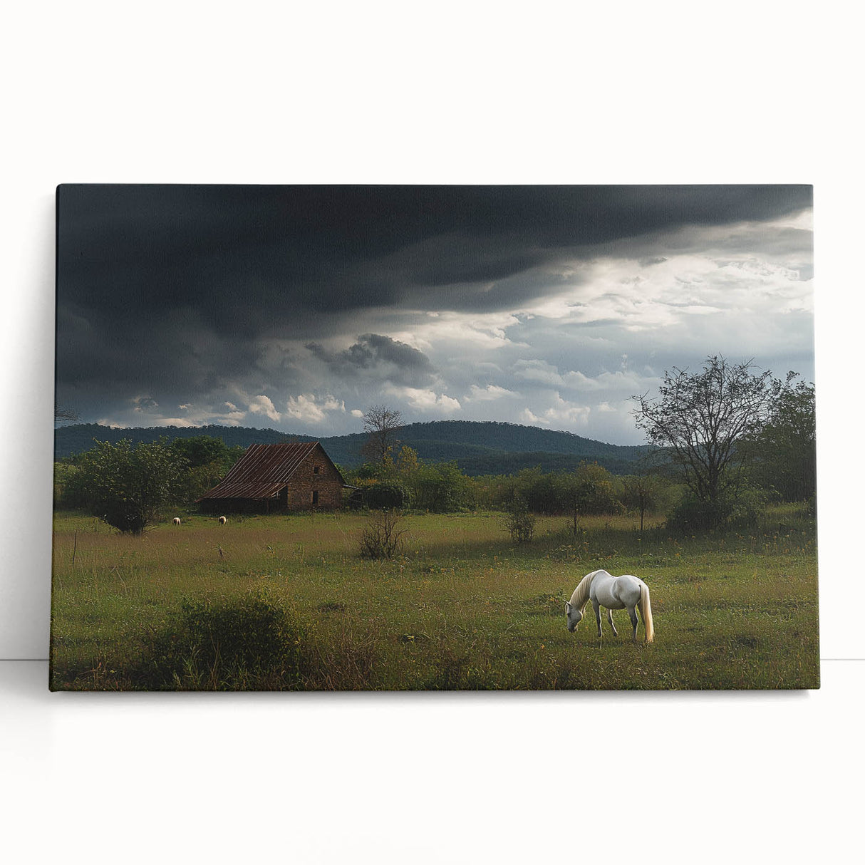 Stretched canvas artwork depicting a serene countryside landscape with rolling hills and vibrant greenery, leaning against a rustic wooden wall, ideal for home decor.