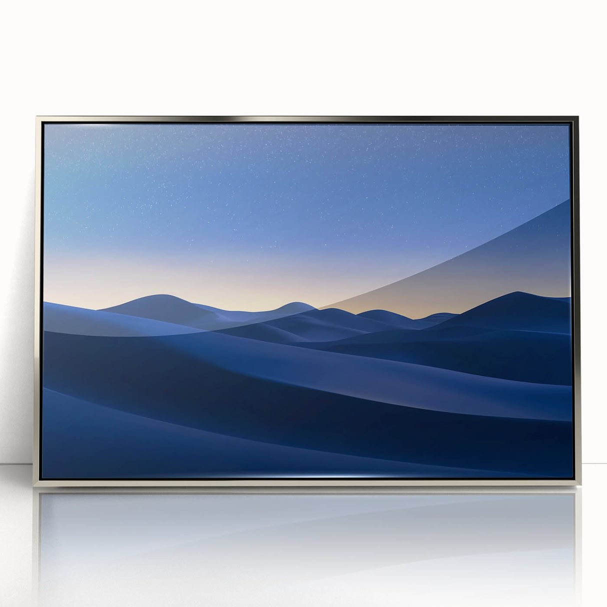 Framed acrylic artwork depicting a serene desert landscape with vibrant orange and yellow hues. The piece is elegantly displayed in a sleek silver frame, enhancing modern decor.