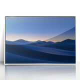 Framed acrylic artwork depicting a serene desert landscape, featuring sandy dunes, vibrant hues of orange and yellow, and a clear blue sky, perfect for home decor.