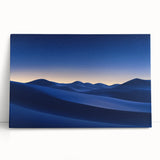 Vibrant desert landscape canvas art featuring warm tones of sand and orange sunset, elegantly leaning against a neutral wall, perfect for home decor.