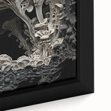 Close-up of textured black wall art featuring natural elements in vibrant colors on a large framed canvas.