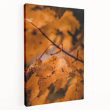 Side view of a large stretched canvas depicting a fall-themed landscape in warm orange and brown tones.