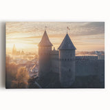Stretched canvas artwork depicting a scenic landscape featuring a majestic castle surrounded by lush greenery and a clear blue sky, perfect for home decor.