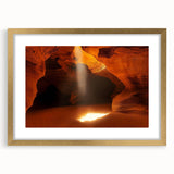 Framed landscape artwork showcasing intricate cave designs in gold tones, complete with a mat for added elegance, perfect for enhancing home decor.