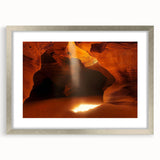 Elegant silver-framed landscape art print showcasing a serene cave scene, accented with a white mat, perfect for enhancing home decor and wall aesthetics.