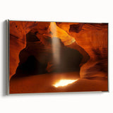 Framed canvas artwork showcasing a stunning landscape scene with caves, presented in a sleek silver frame, perfect for enhancing modern home decor.
