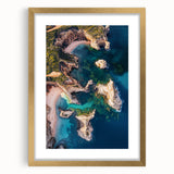 Elegant gold-framed landscape artwork showcasing majestic cliffs under a clear blue sky, matted for a refined presentation, ideal for home decor.