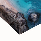 Close-up of a stretched canvas featuring a vibrant landscape with dramatic cliffs and rich colors, perfect for enhancing home decor with natural beauty.
