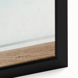 Framed canvas artwork showcasing a serene beach landscape, highlighting vibrant colors of the ocean and sky, perfect for adding a coastal vibe to home decor.