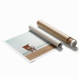 Vibrant rolled print of a serene beach landscape, showcasing soft pastel colors and gentle waves, elegantly packaged in a protective cardboard tube for easy display.