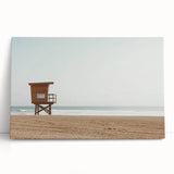 Vibrant stretched canvas artwork depicting a serene beach landscape with soft blue skies and gentle waves, perfect for enhancing coastal-themed decor. Ideal for home or office walls.