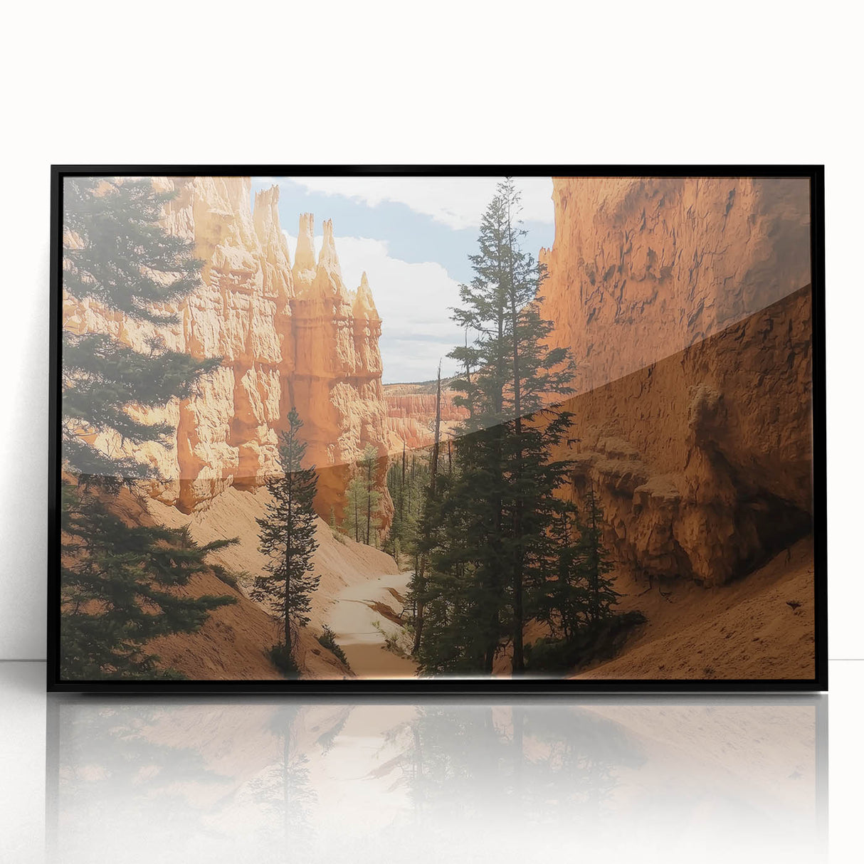 Framed acrylic artwork showcasing a stunning landscape of canyons in rich earthy tones, featuring a sleek black frame that enhances the dramatic scenery. Perfect for modern decor.