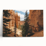 Stretched canvas artwork depicting a vibrant landscape of canyons with rich earthy tones, ideal for home decor or office settings. This stunning piece adds depth and color, enhancing any space.