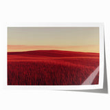 Rolled landscape print showcasing a serene countryside scene with vibrant greens and soft blue skies, carefully packaged in a protective cardboard tube. Ideal for home decor.