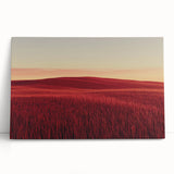 Stretched canvas artwork depicting a serene countryside landscape with lush green fields and a vibrant blue sky, leaning against a rustic wall, perfect for home decor.
