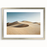 Elegant silver-framed landscape artwork depicting a serene desert scene, featuring soft hues of beige and warm gold, complete with a white mat and a sleek presentation. Ideal for enhancing modern home decor.