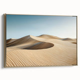 Framed canvas depicting a serene desert landscape with warm gold tones, showcasing rolling dunes and a clear blue sky, ideal for modern home decor.