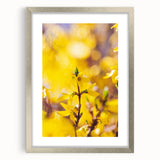 Textured abstract art print in soft green and yellow tones, framed in silver, ideal for bedroom wall decor.