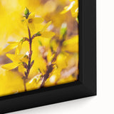 Close-up of a framed canvas featuring textured, colorful art depicting spring, with a black background.