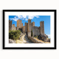 Framed landscape artwork showcasing an elegant castle surrounded by lush greenery, featuring a sleek black mat and frame, ideal for home décor.