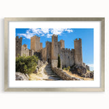 Elegant silver-framed landscape artwork of a majestic castle, displayed with a mat for added depth, showcasing intricate details and vibrant colors, ideal for home decor.