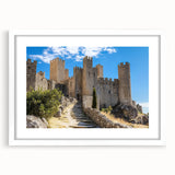 Elegant white-framed landscape artwork featuring a picturesque castle scene, enhanced with a mat for added depth, perfect for home decor.