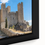 Close-up of a framed canvas depicting a serene landscape with a majestic castle, featuring vibrant colors and intricate details, perfect for home decor.