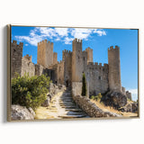 Framed canvas artwork showcasing a vibrant landscape with a majestic castle in a scenic natural setting, highlighted by an elegant gold frame for a luxurious presentation.