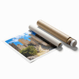 Rolled print showcasing a stunning landscape featuring a majestic castle surrounded by lush greenery and a serene lake, ideal for home decor.