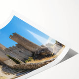 Rolled canvas print showcasing a stunning landscape with a majestic castle surrounded by lush greenery and vibrant skies, elegantly packaged in a protective tube for easy transport.