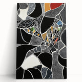 Abstract geometric stretched canvas artwork in bold colors, featuring sharp angles and dynamic shapes, leaning against a neutral wall, perfect for modern decor.