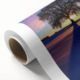 Landscape scene printed on rolled canvas, showcasing serene countryside with vibrant greenery and a clear blue sky, perfect for home decor.