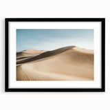 Framed landscape artwork depicting a serene desert scene, featuring rich earthy tones and a black mat, perfect for enhancing modern home decor.