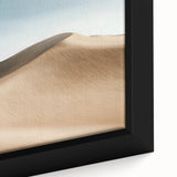 Framed canvas artwork depicting a vibrant desert landscape at sunset, showcasing rich orange and purple hues, with intricate details of cacti and sand dunes, ideal for home decor.