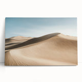 Desert landscape stretched canvas art featuring warm earth tones, showcasing rolling sand dunes and a clear blue sky, perfect for contemporary home decor.